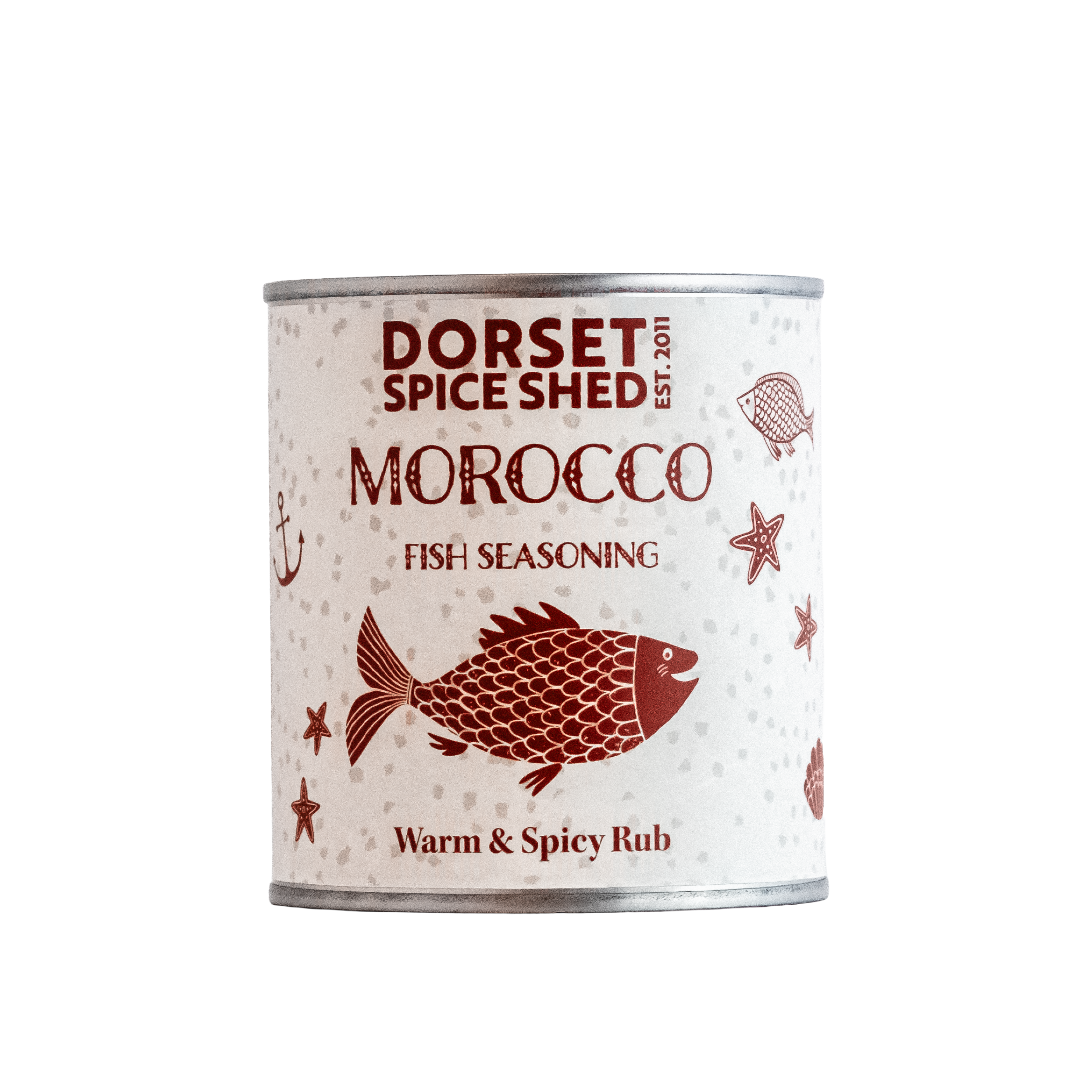 A tin of Dorset Spice Shed Morocco Fish Seasoning, featuring a white label with red illustrations of a fish, starfish, and anchor, on a solid white background.